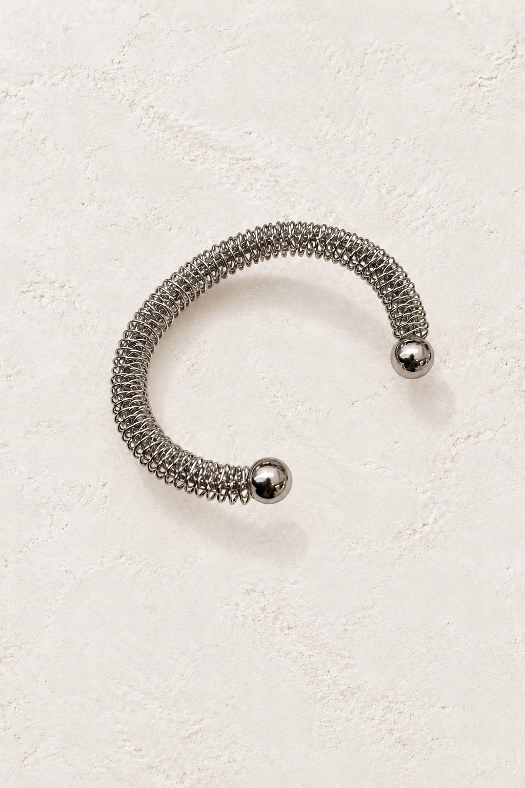 Nerina Silver Mesh Cuff on warm ivory plaster