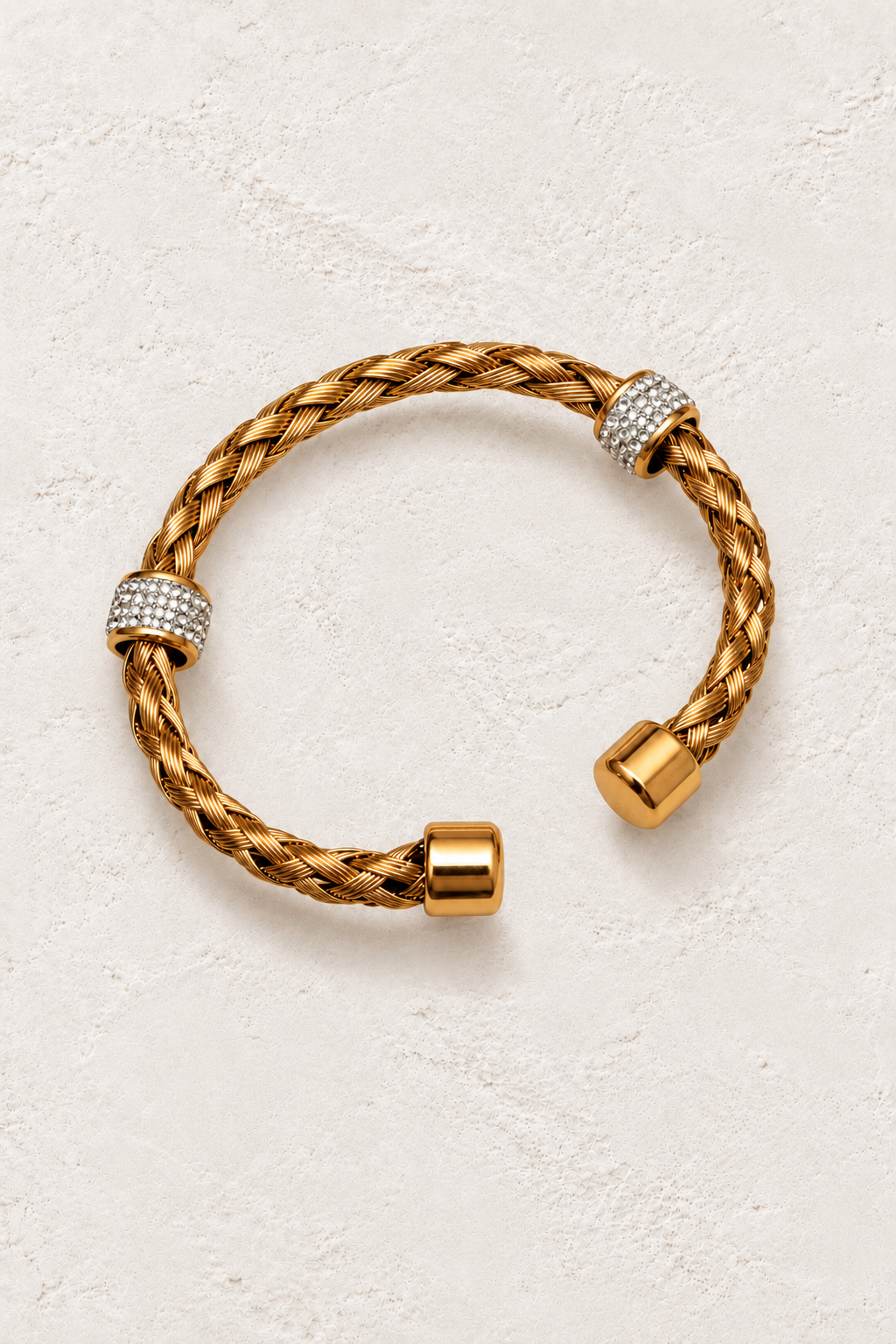 Safira Gold Braided Crystal Cuff on warm ivory plaster