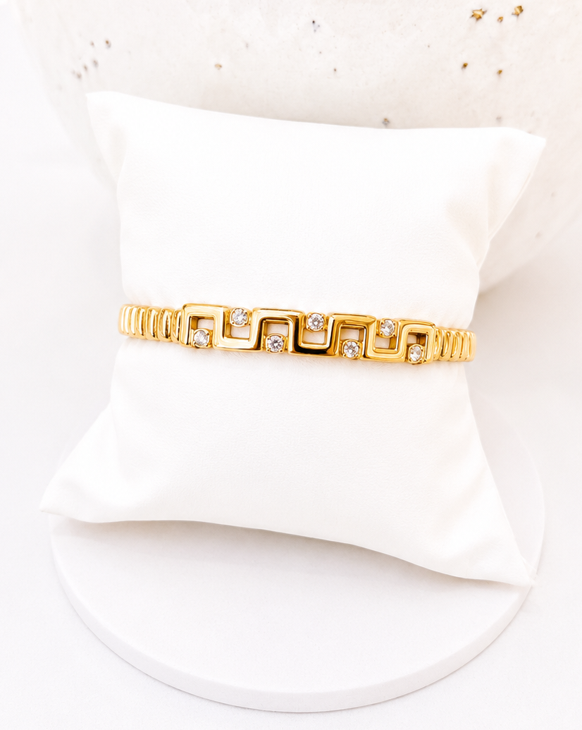 
                  
                    Close-up of the Marcella Gold Geometric Crystal Bangle
                  
                