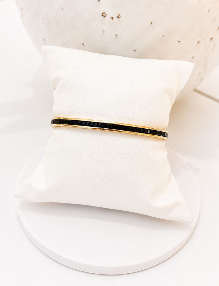 
                  
                    Close-up of the Noiré Black Crystal Gold Bangle
                  
                