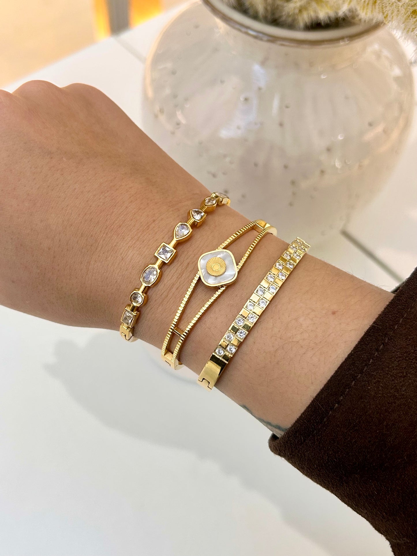 
                  
                    Model wearing the Aviora Gold Mixed-Cut Crystal Bangle stacked with Boho & Mala gold bracelets
                  
                