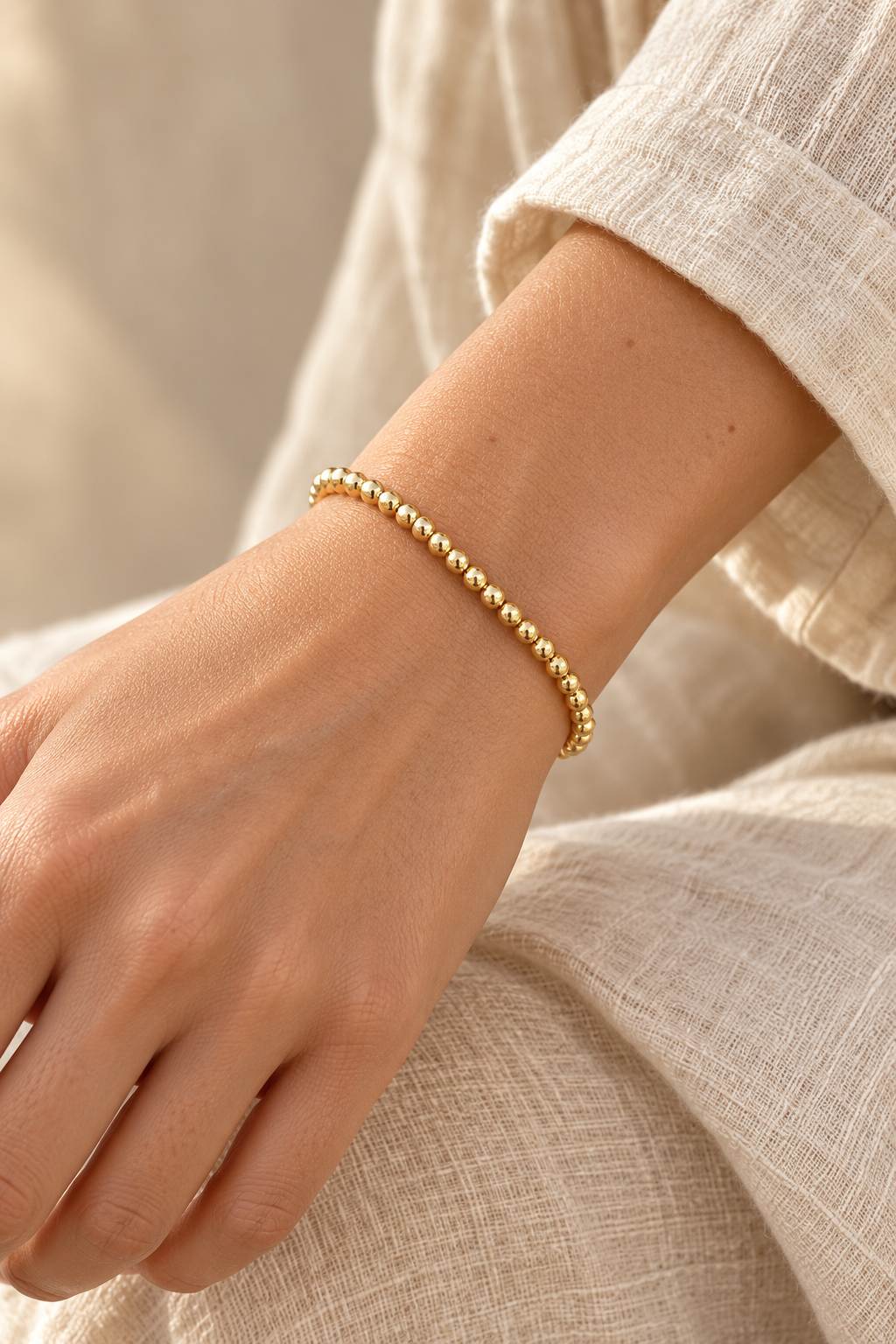 4mm Gold Plated Beaded Elastic Bracelet TF worn on a model's wrist