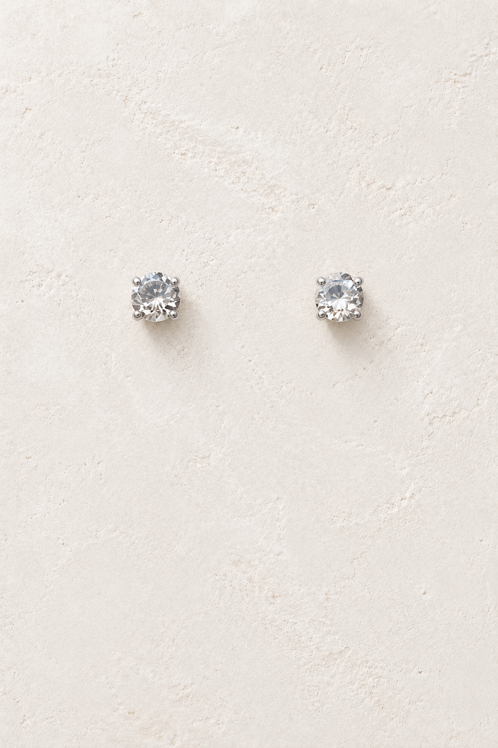 
                  
                    5mm CZ Clear Stud on cream plaster background
                  
                