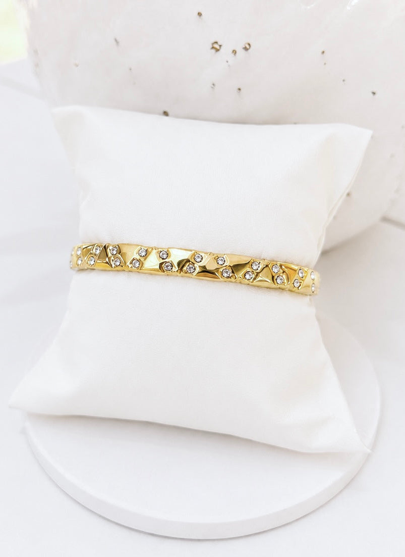 
                  
                    Close-up of the Stellara Textured Gold Scattered Crystal Bangle
                  
                