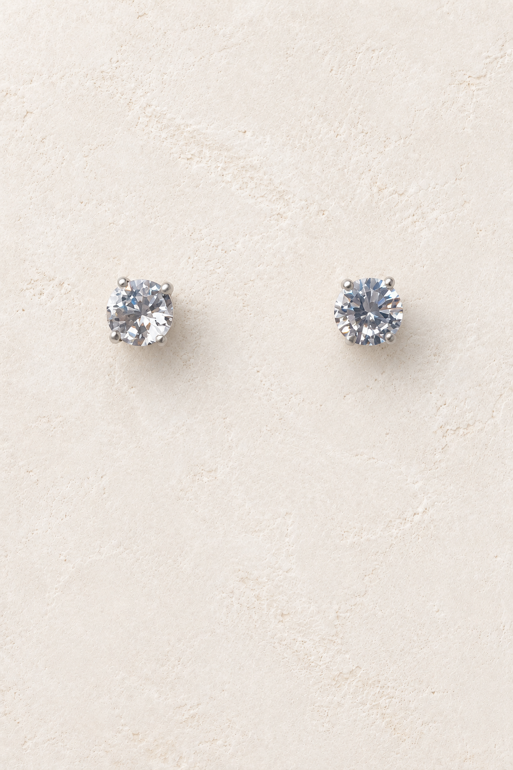 
                  
                    6mm CZ Clear Stud on cream plaster background
                  
                