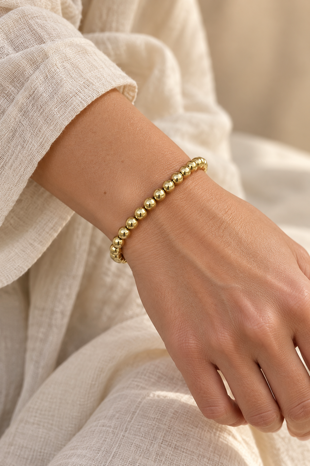 6mm Gold Plated Beaded Elastic Bracelet TF worn on a model's wrist