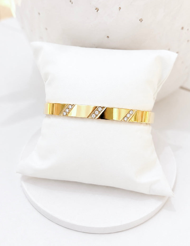 
                  
                    Close-up of the Lucienne Brushed Gold Diagonal Crystal Bangle
                  
                