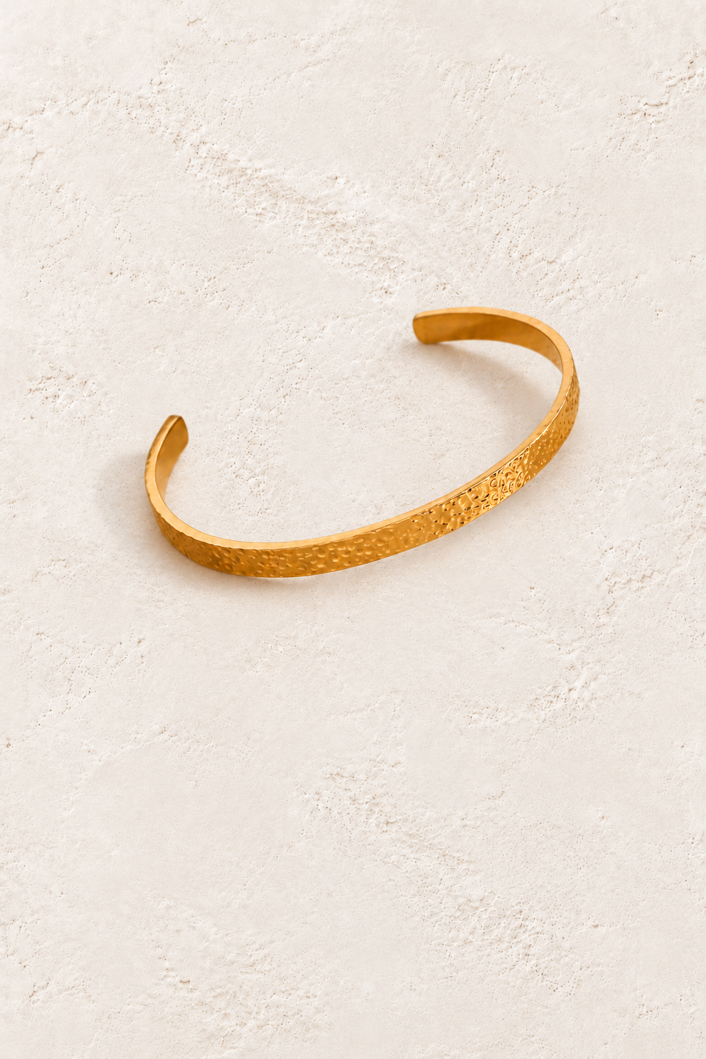 Classic Textured Gold Cuff on warm ivory plaster