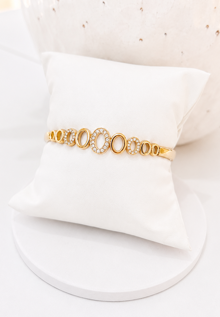
                  
                    Close-up of the Amoura Open Oval Gold Crystal Bangle
                  
                