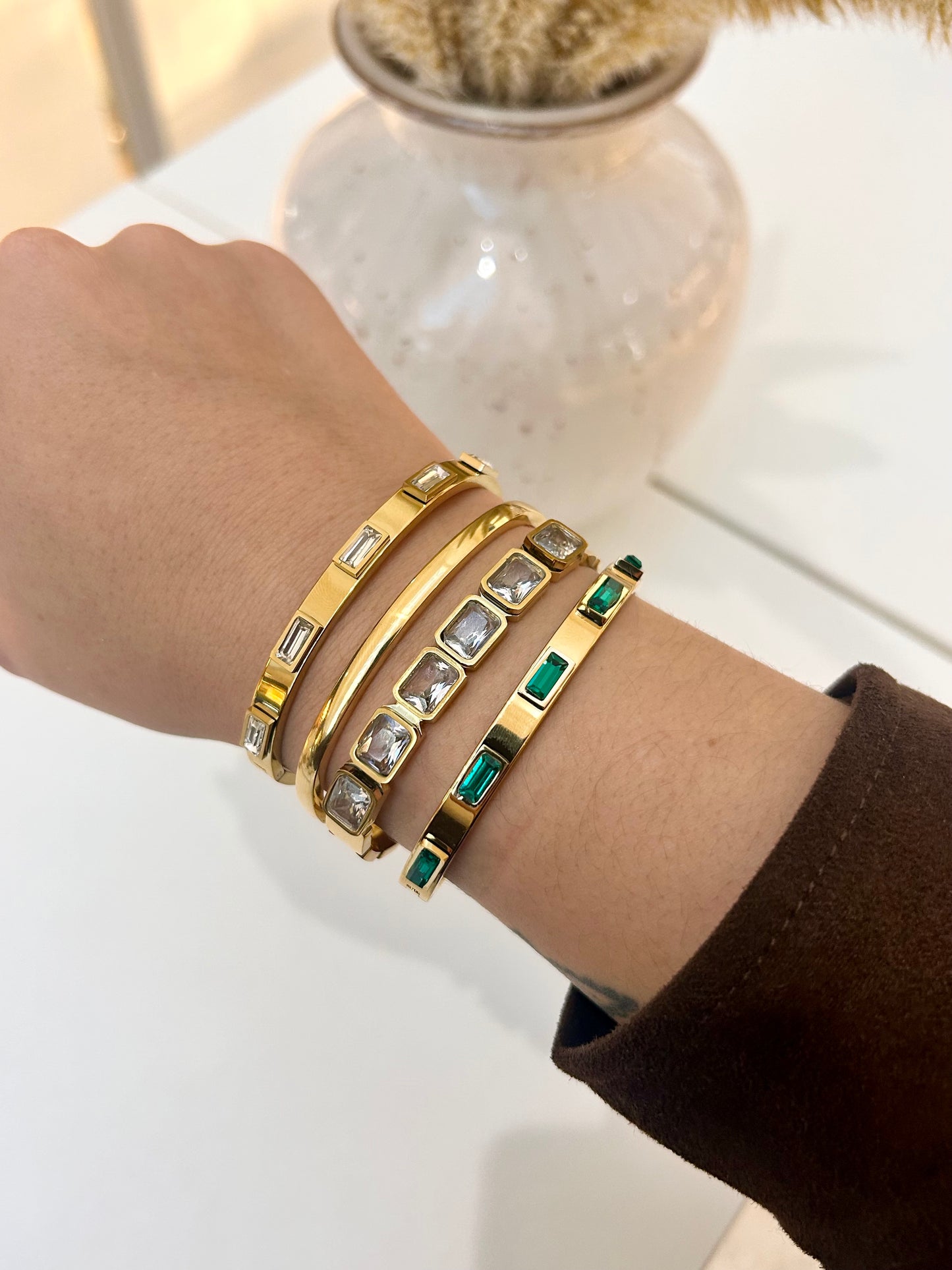 
                  
                    Stack of Boho & Mala waterproof gold bangles worn on a model's wrist
                  
                