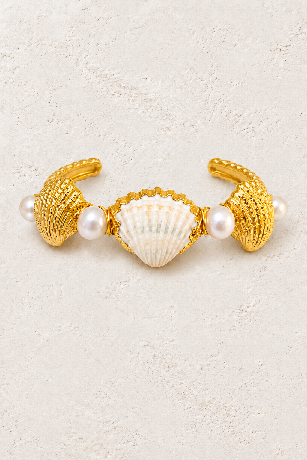 Coralia Shell & Freshwater Pearl Cuff on warm ivory plaster