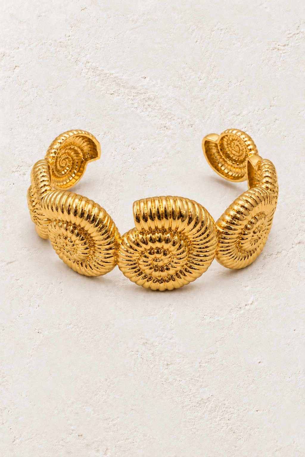 Nautila Statement Cuff on warm ivory plaster