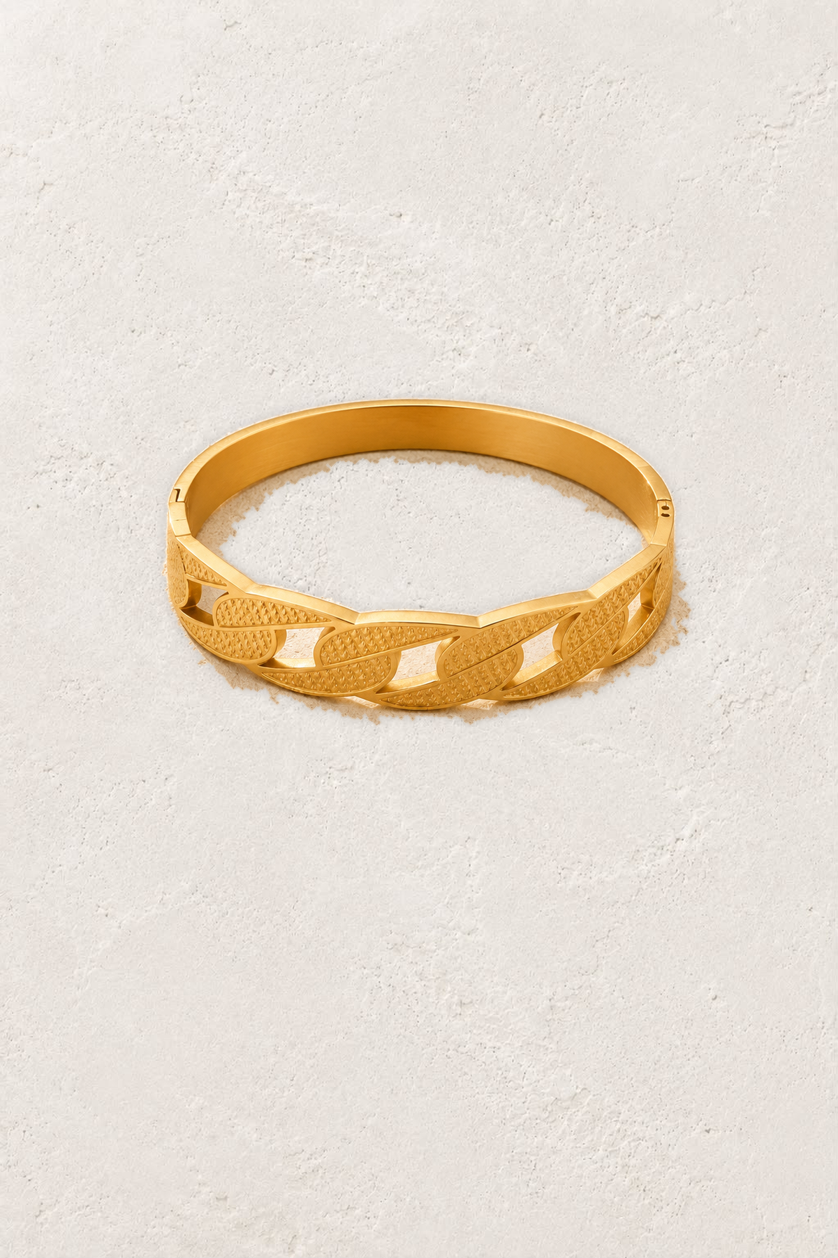Aurora Link Gold Bangle on the reference plaster background