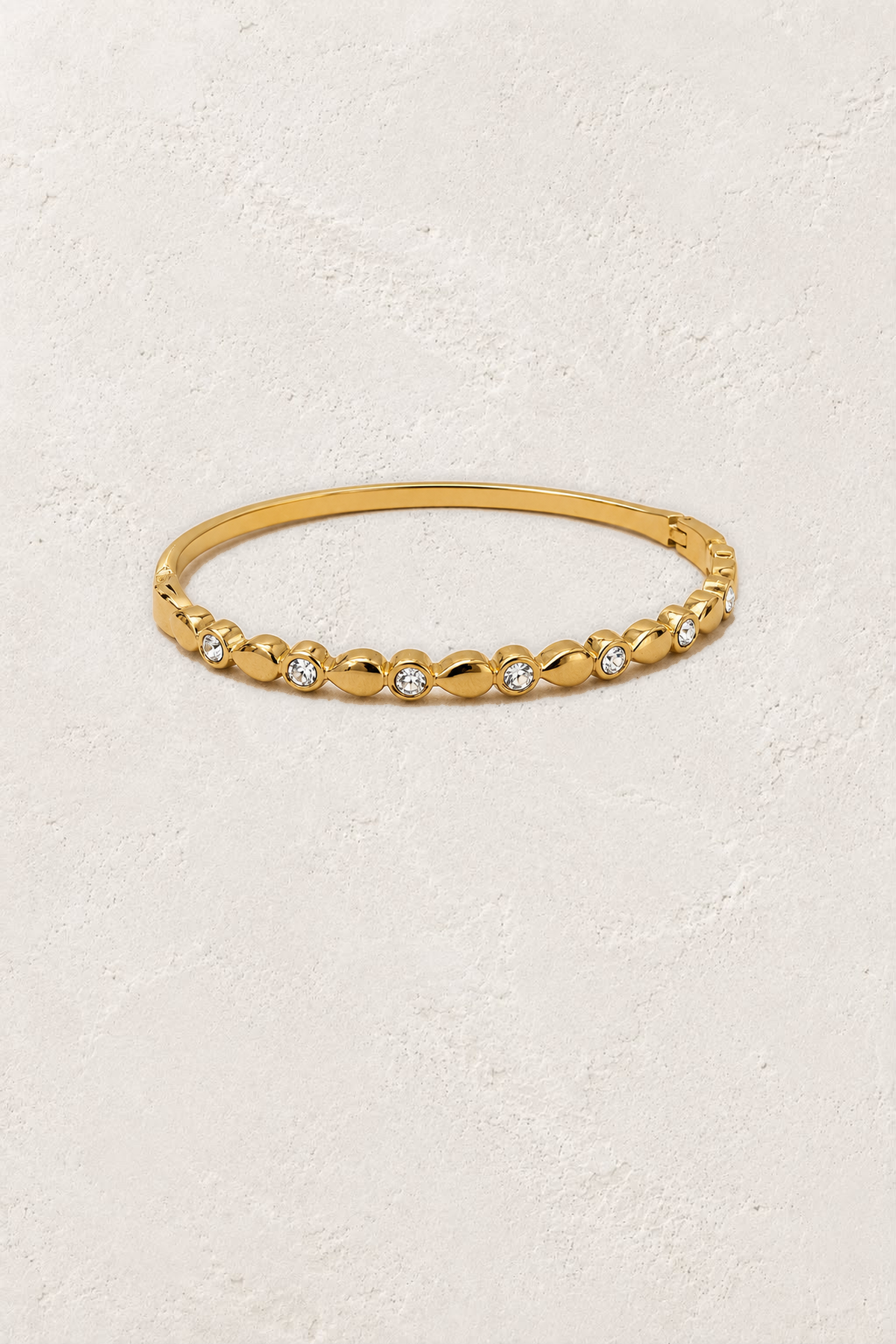 
                  
                    Aurette Gold Beaded Crystal Bangle on the reference plaster background
                  
                
