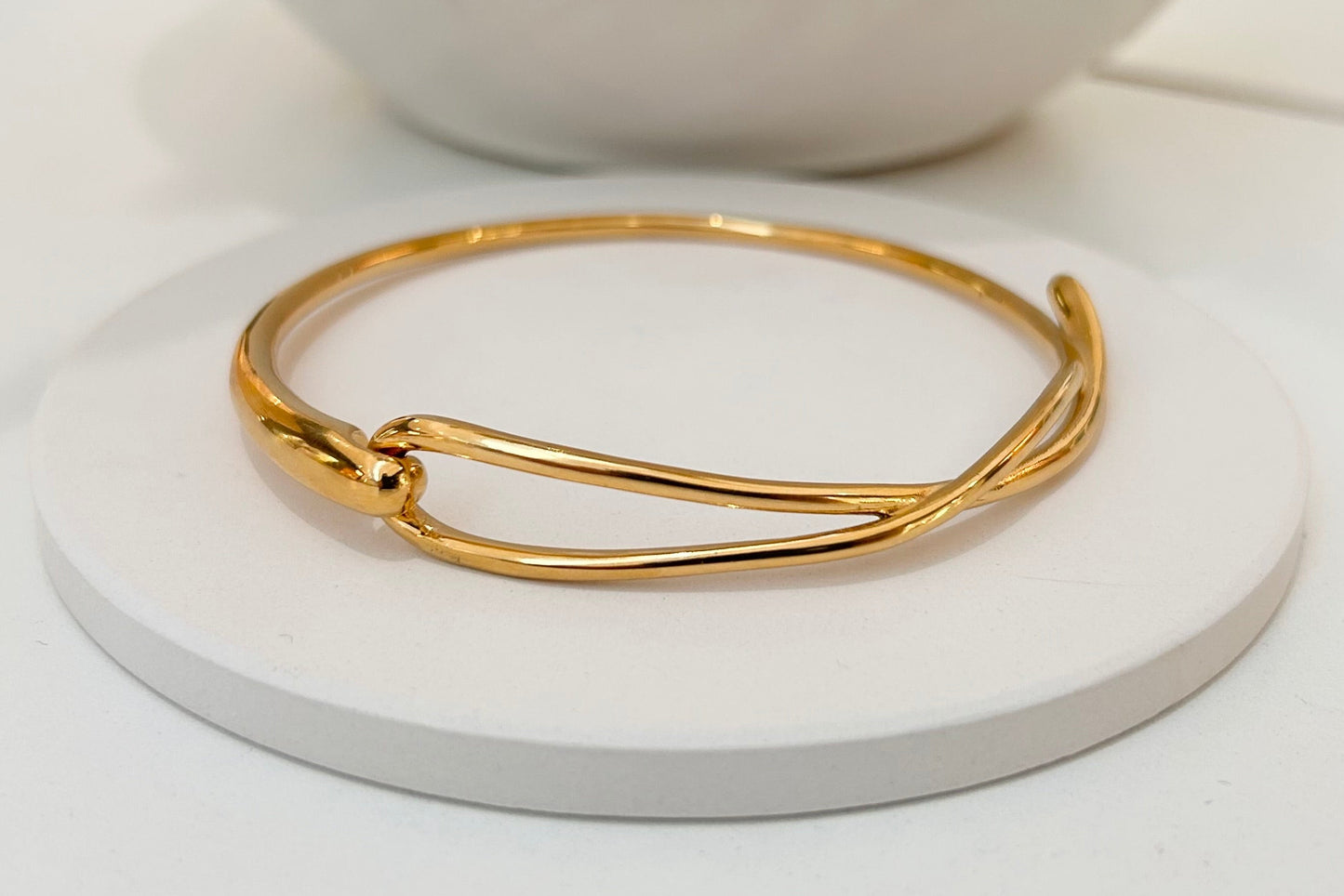 
                  
                    Close-up of the Élanora Gold Intertwined Open Bangle
                  
                