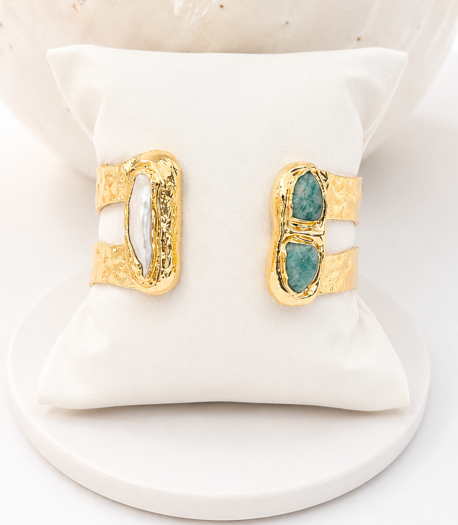 
                  
                    Gold, amazonite and freshwater pearl open cuff bangle  on a white cushion with a marble background
                  
                