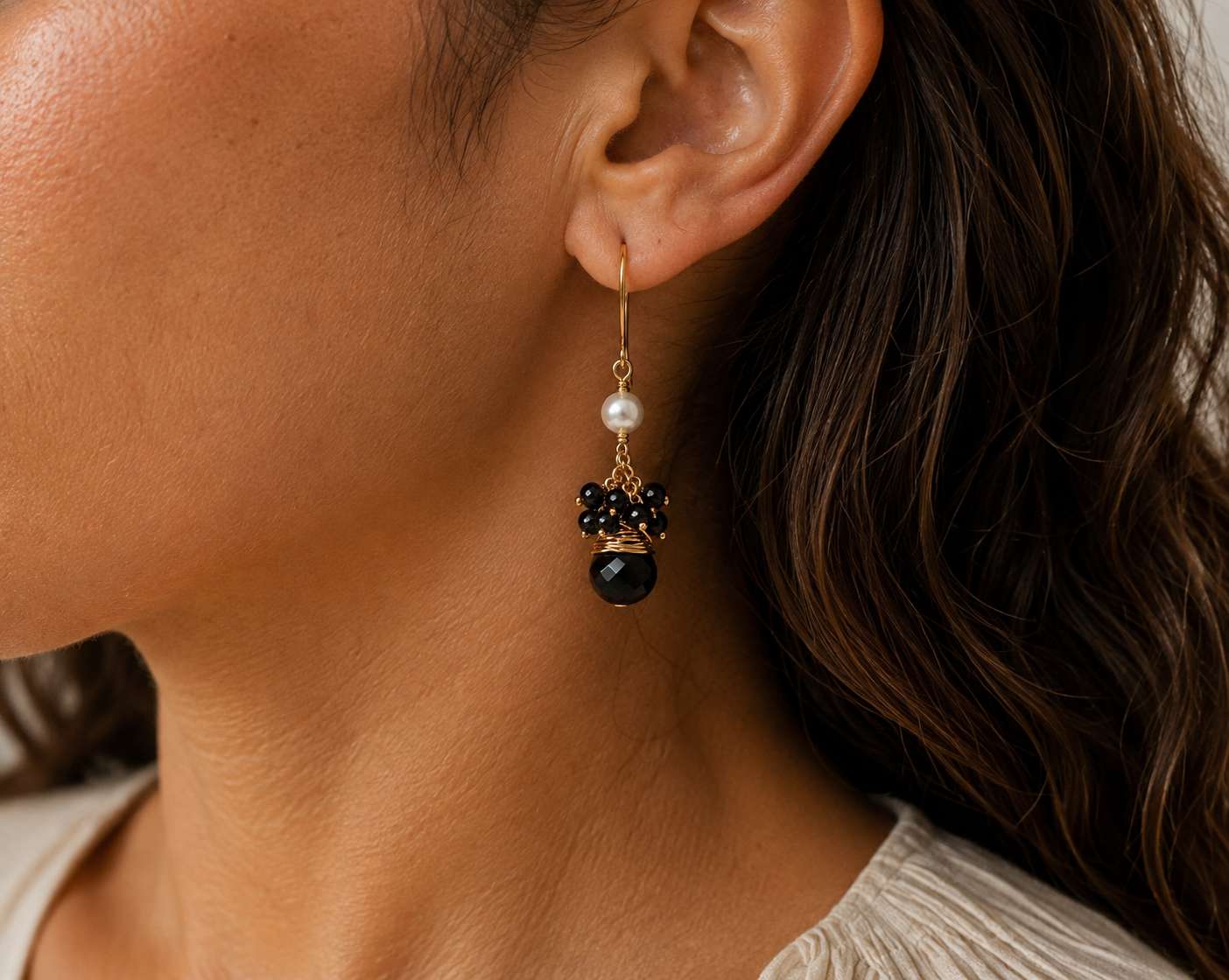 
                  
                    Black obsidian gemstone earring on models ears 
                  
                