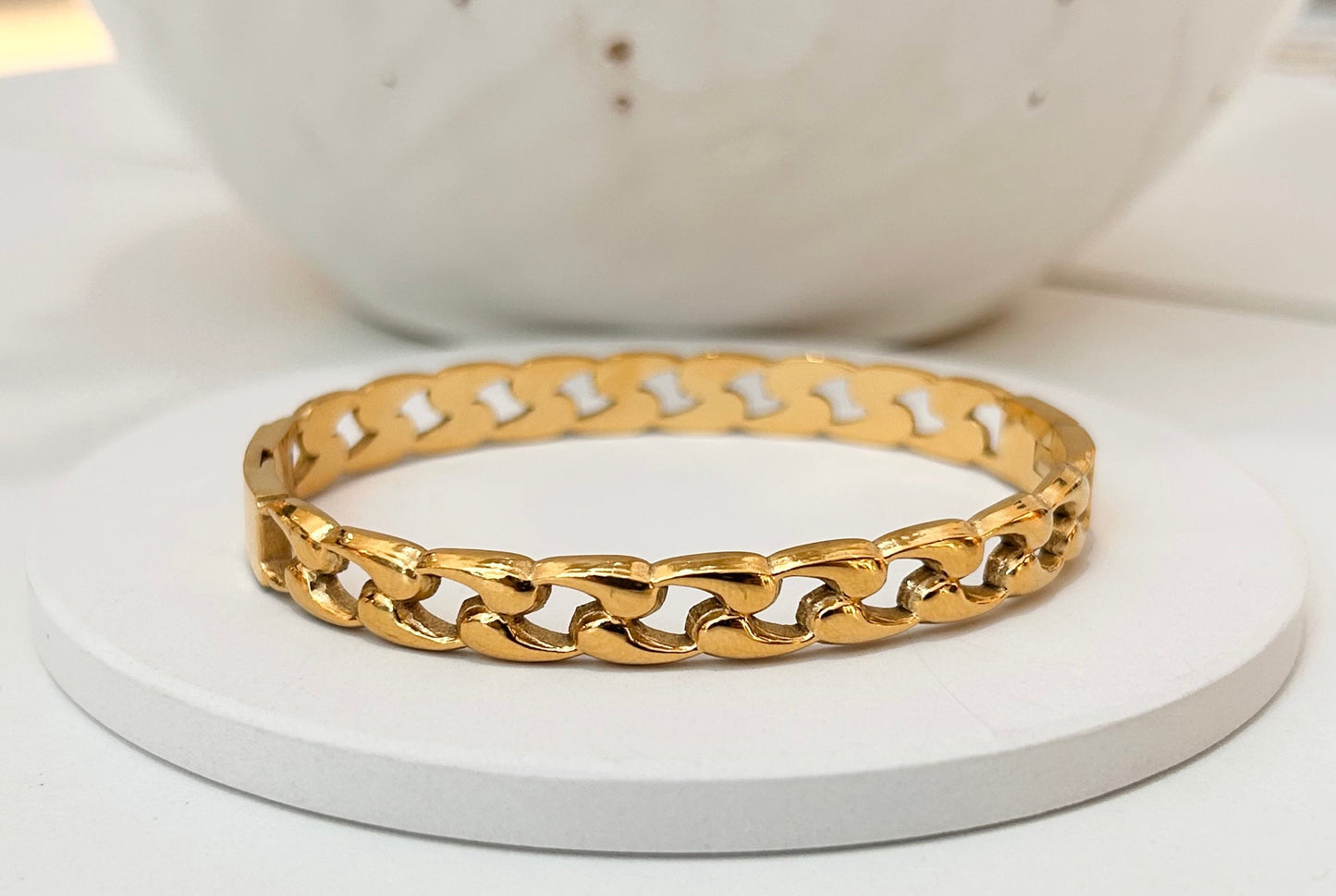 
                  
                    Marais Gold Curb Chain Bangle displayed on a white stand
                  
                