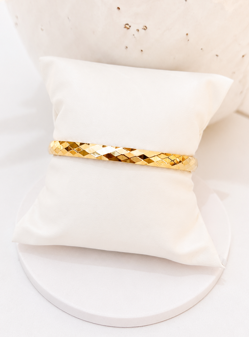 
                  
                    Close-up of the Valora Faceted Gold Bangle
                  
                