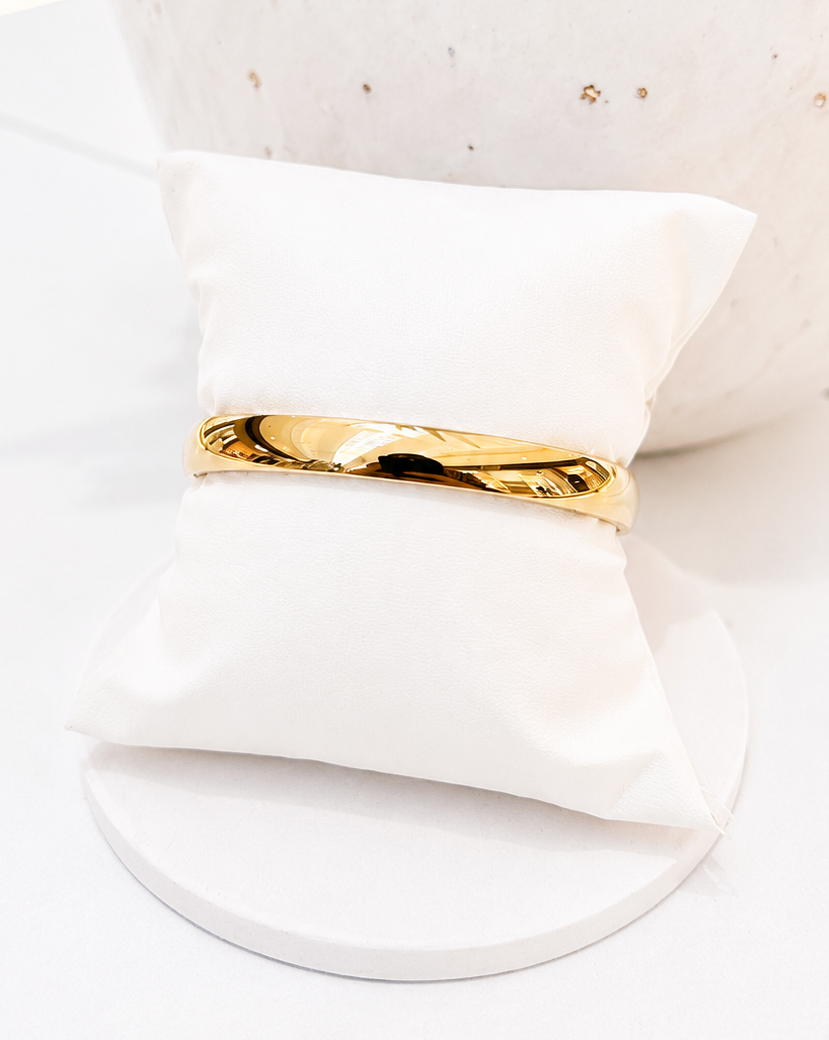 
                  
                    Close-up of the Marvelle Classic Rounded Gold Bangle
                  
                