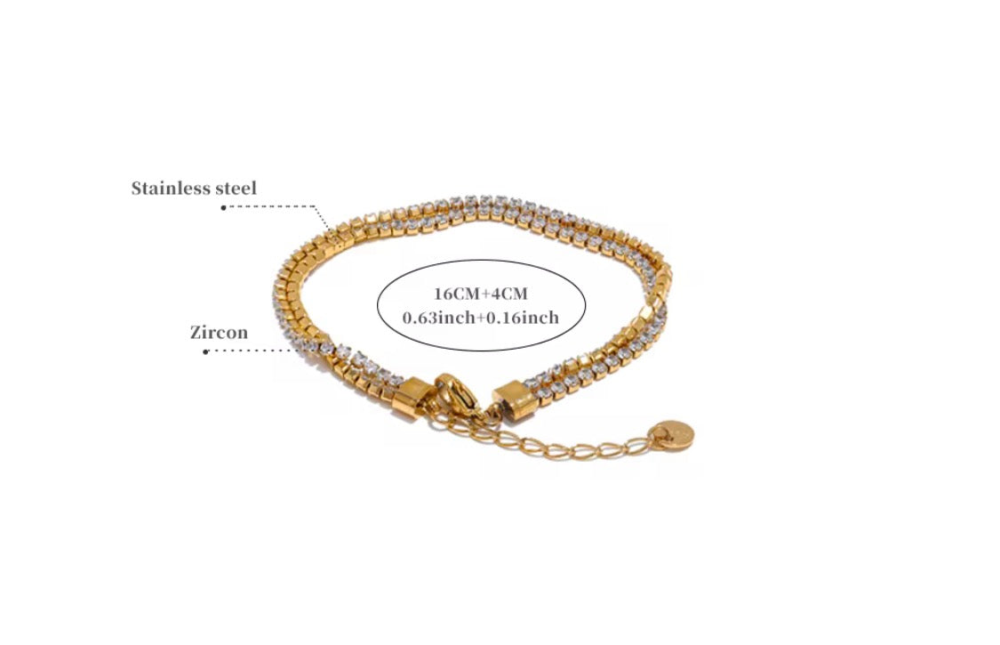 
                  
                    Golden Glow Crystal Layered Bracelet displayed on a white stand
                  
                