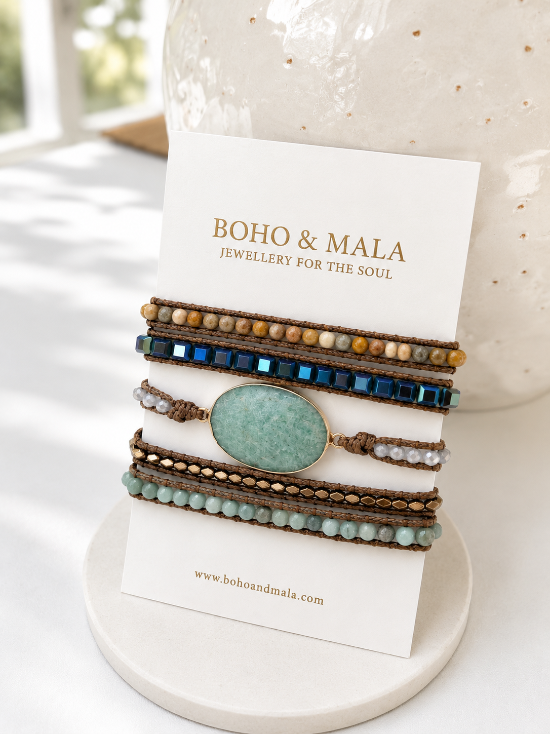 
                  
                    Set of beaded amazonite wrap bracelets on a branded card with 'Boho & Mala' displayed.
                  
                