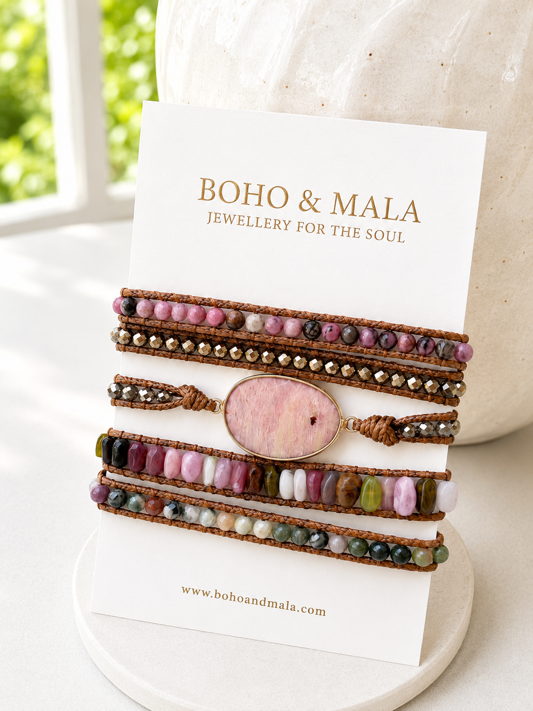 
                  
                    Set of colourful beaded rhodonite mixed wrap bracelets on a white card with 'Boho & Mala' branding.
                  
                