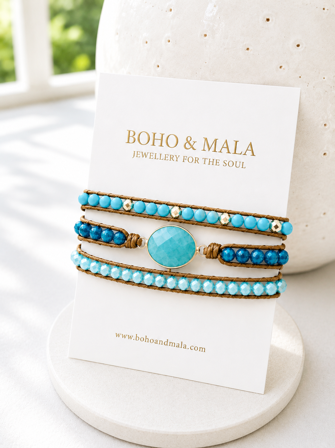 
                  
                    Turquoise beaded bracelet with a large turquoise stone on a 'Boho & Mala' branded card.
                  
                