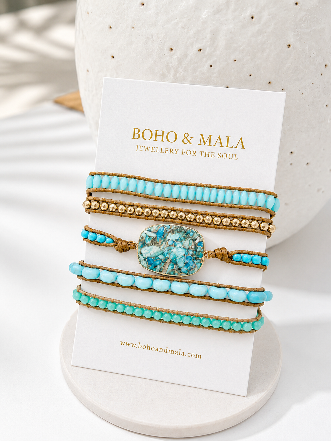 
                  
                    Set of turquoise and amazonite beaded bracelets on a branded card with 'Boho & Mala' branding.
                  
                