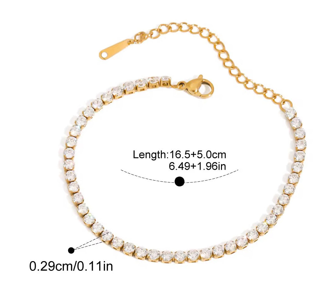 
                  
                    Aurelle Fine Gold Crystal Tennis Bracelet displayed on a white stand
                  
                