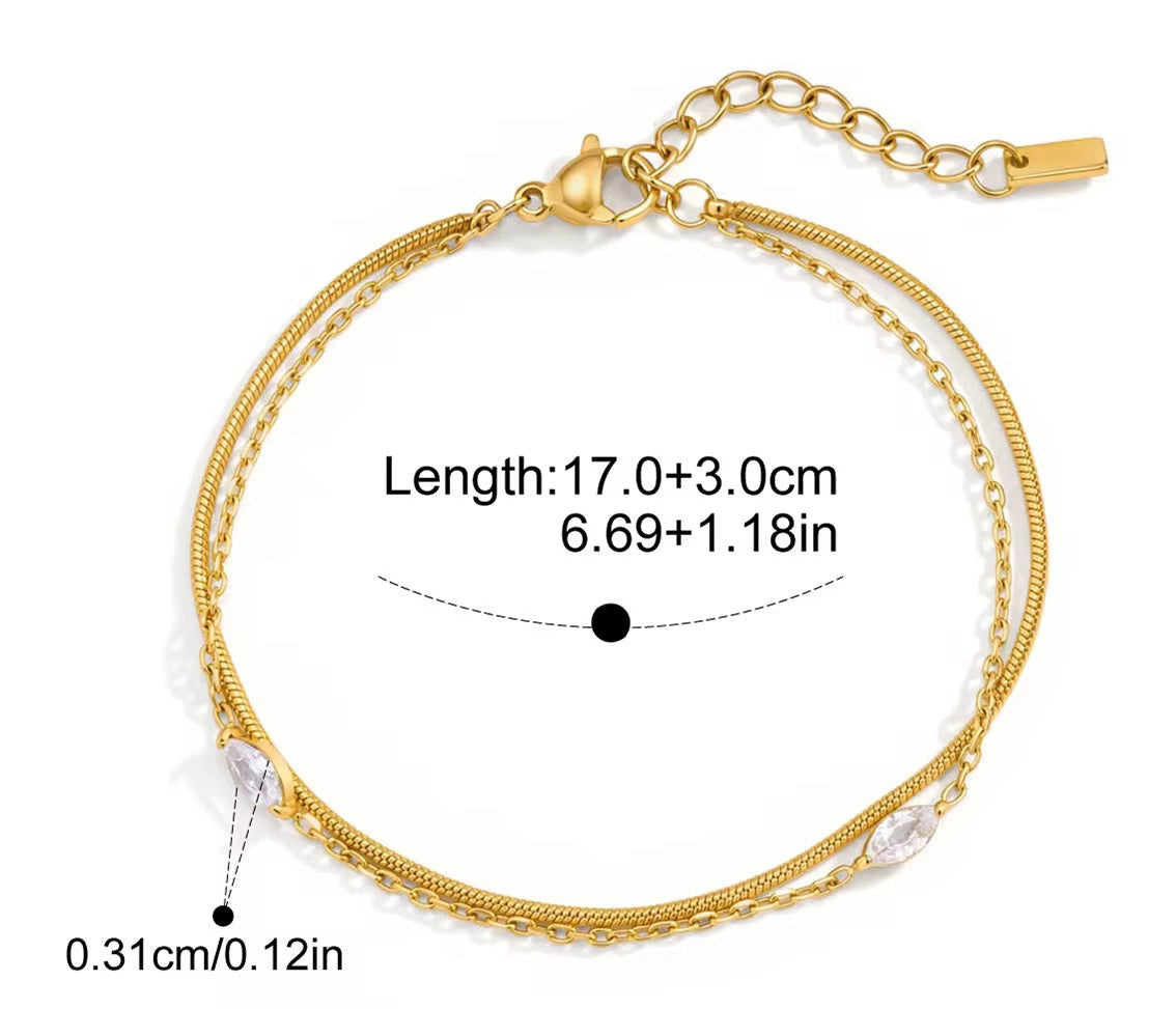 
                  
                    Celeste Gold Crystal Layered Bracelet displayed on a white stand
                  
                