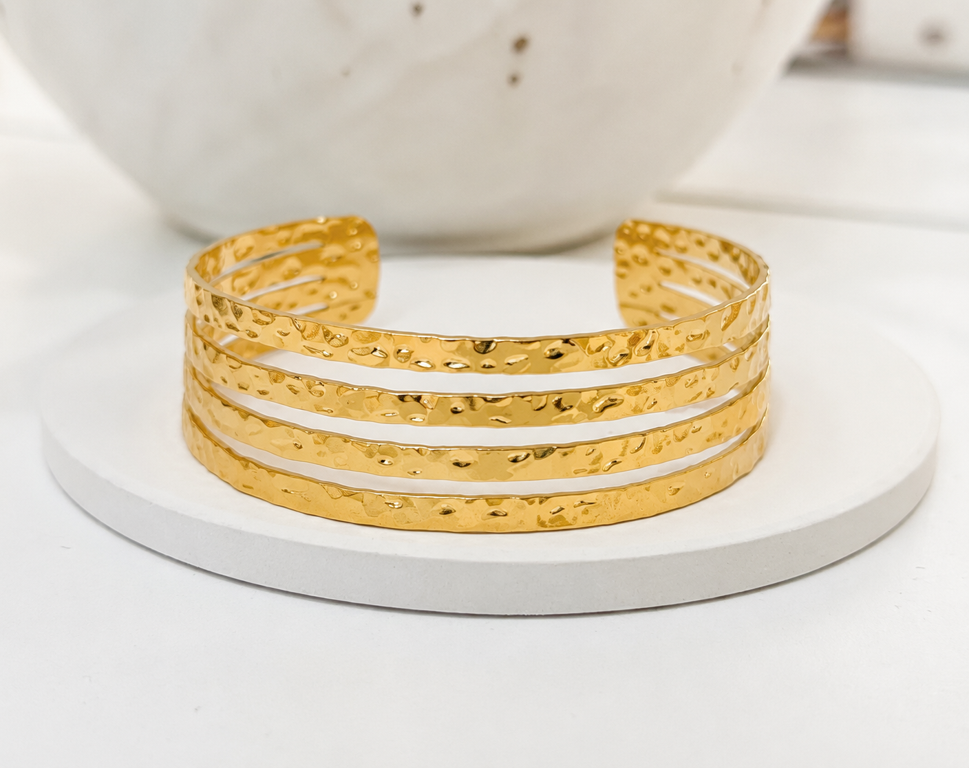 
                  
                    Close-up of the Aurora Textured Gold Bangle
                  
                