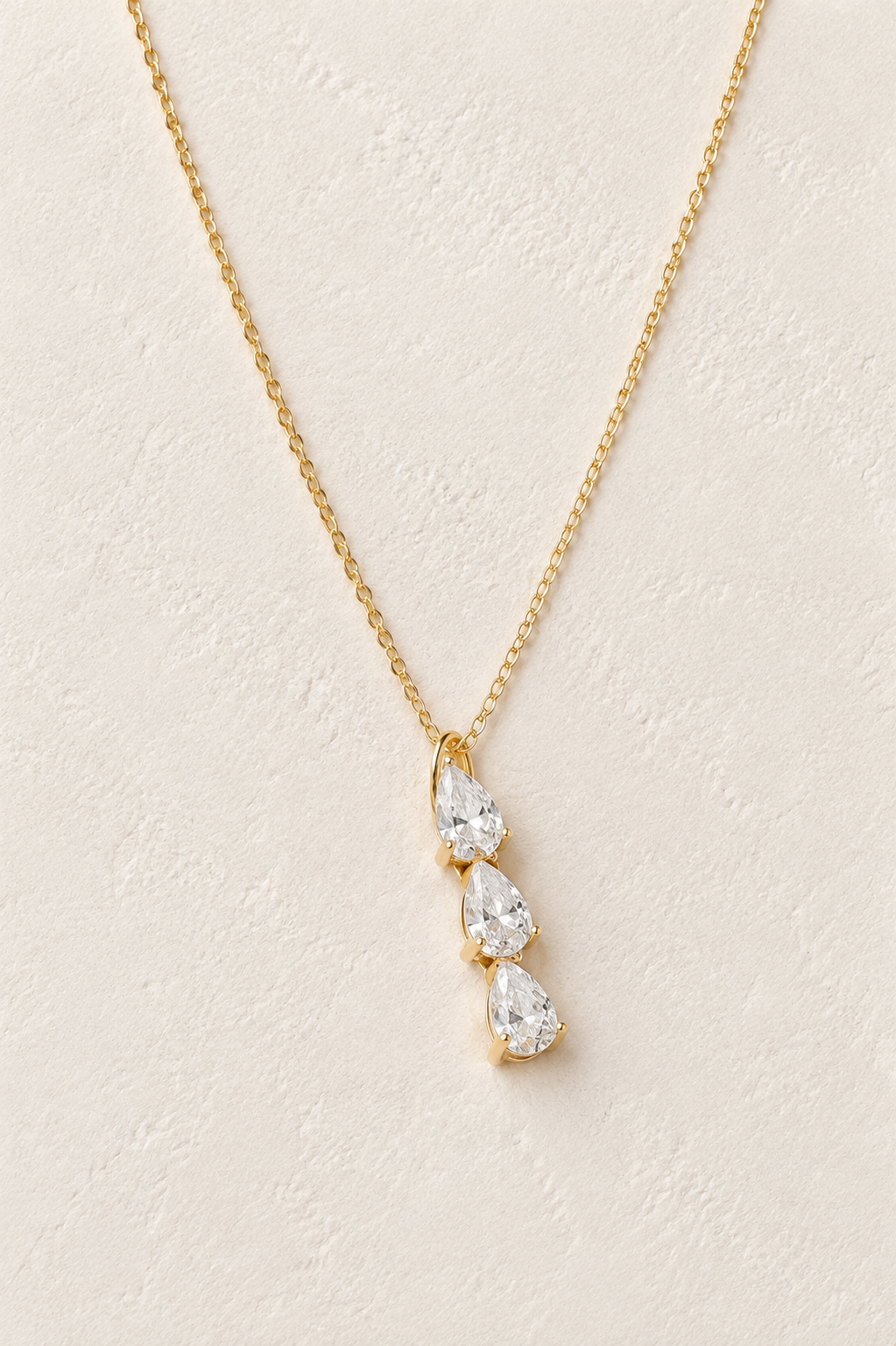
                  
                    Amara Triple Zirconia Drop Necklace – Waterproof Gold-Plated Stainless Steel
                  
                