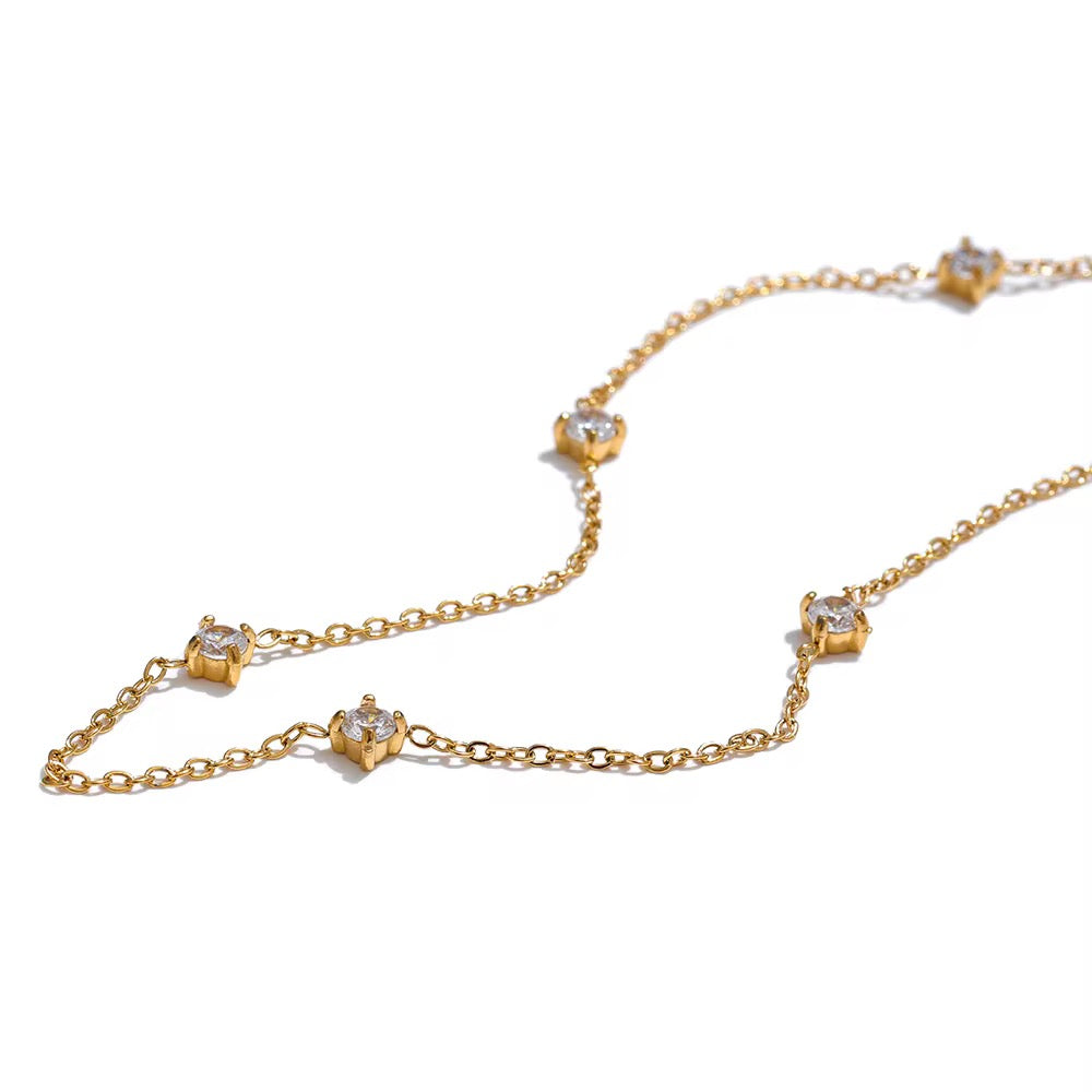 
                  
                    Dainty Crystal Drop Gold Bracelet displayed on a white stand
                  
                