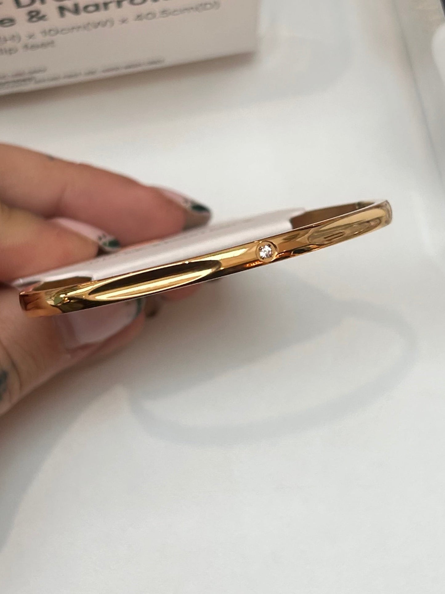 
                  
                    Sola Gold Solitaire Bangle — original display photo
                  
                