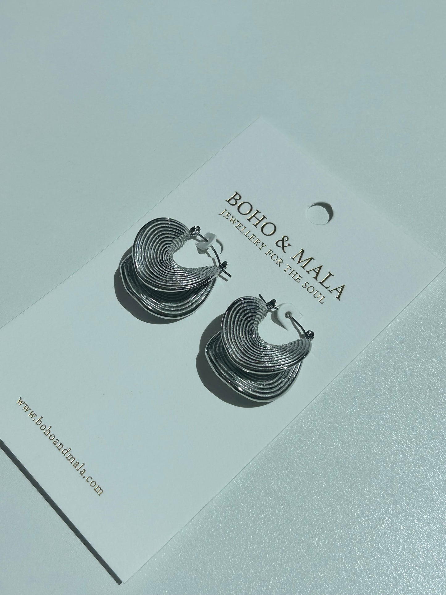 
                  
                    Ravena Silver Ripple Hoop Earrings
                  
                