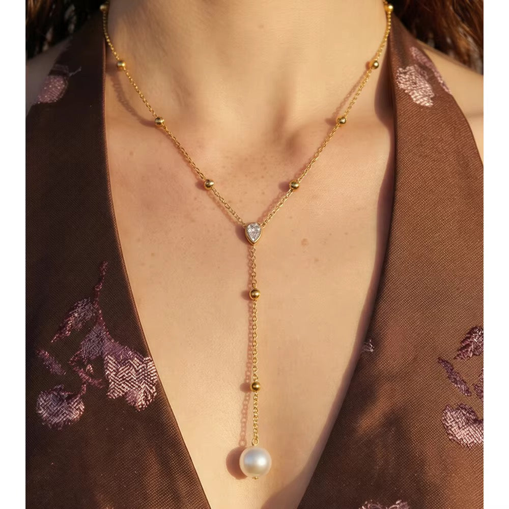 
                  
                    Gold pearl and crystal lariat necklace worn on model
                  
                