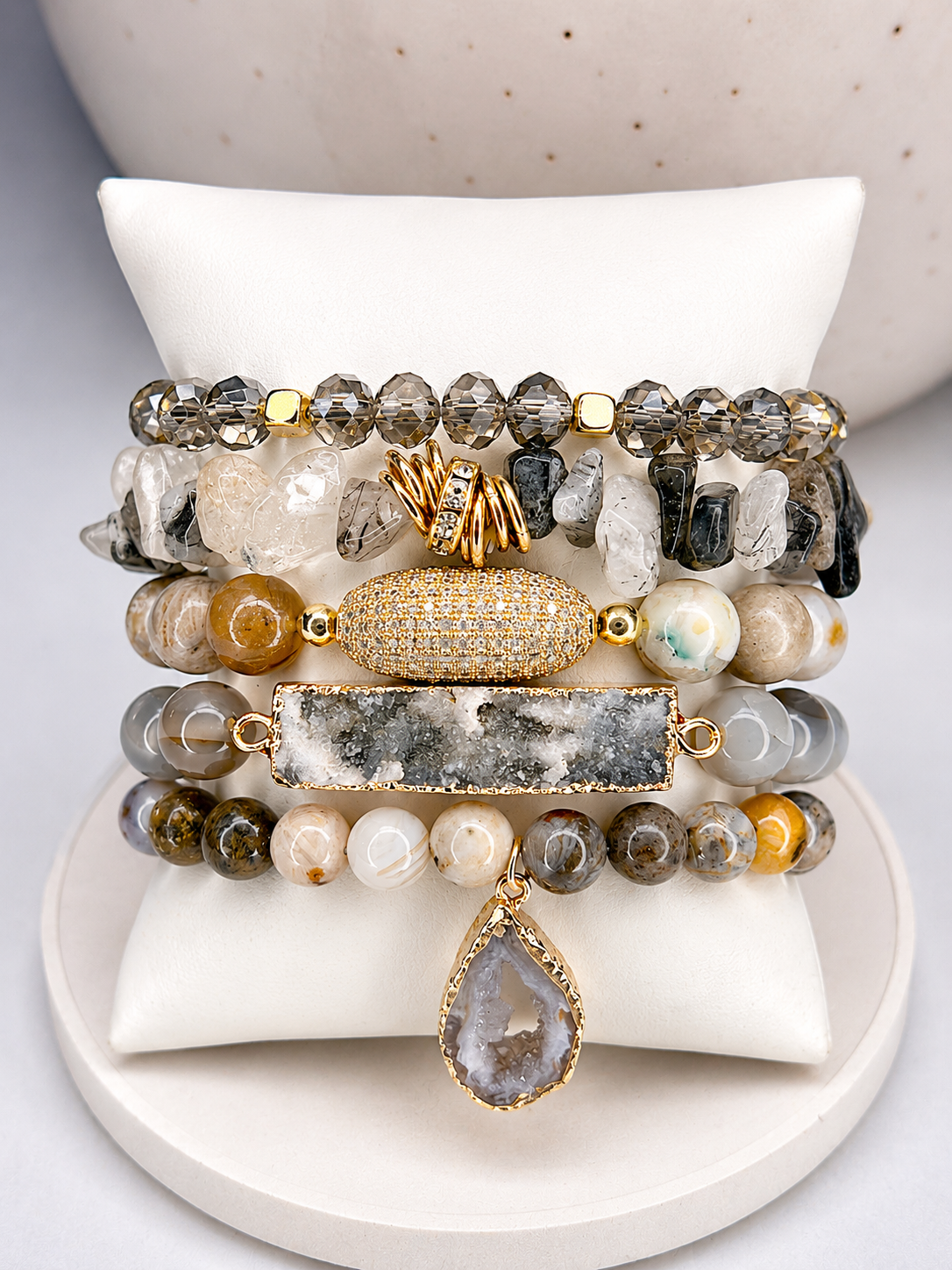 
                  
                    Set of beaded moon bracelets on a white stone surface
                  
                