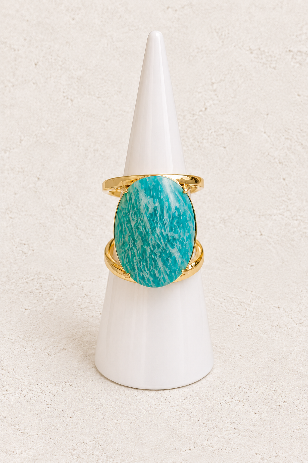 Aurevia Amazonite Statement Ring on white cone against warm textured background