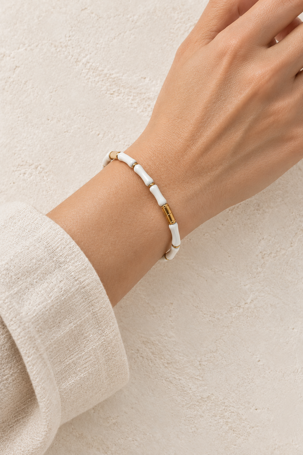 
                  
                    Model wearing Amaya White Enamel & Gold Bangle
                  
                