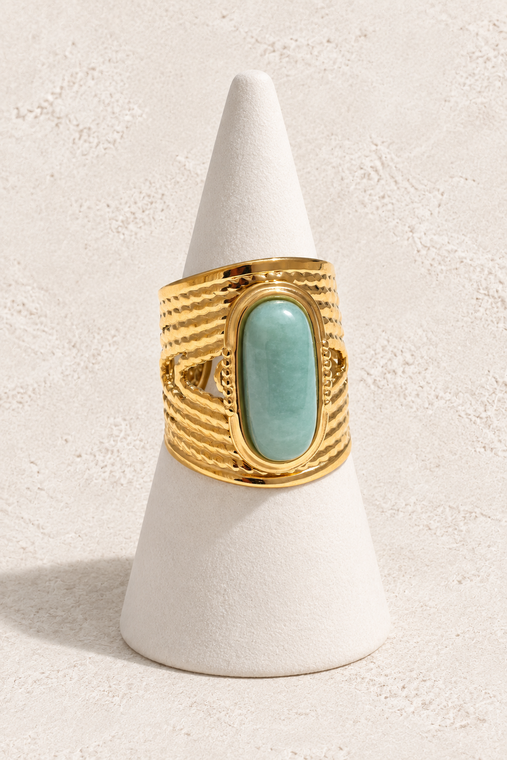 Amazonite Serenity Ring on a white display cone against a warm textured background