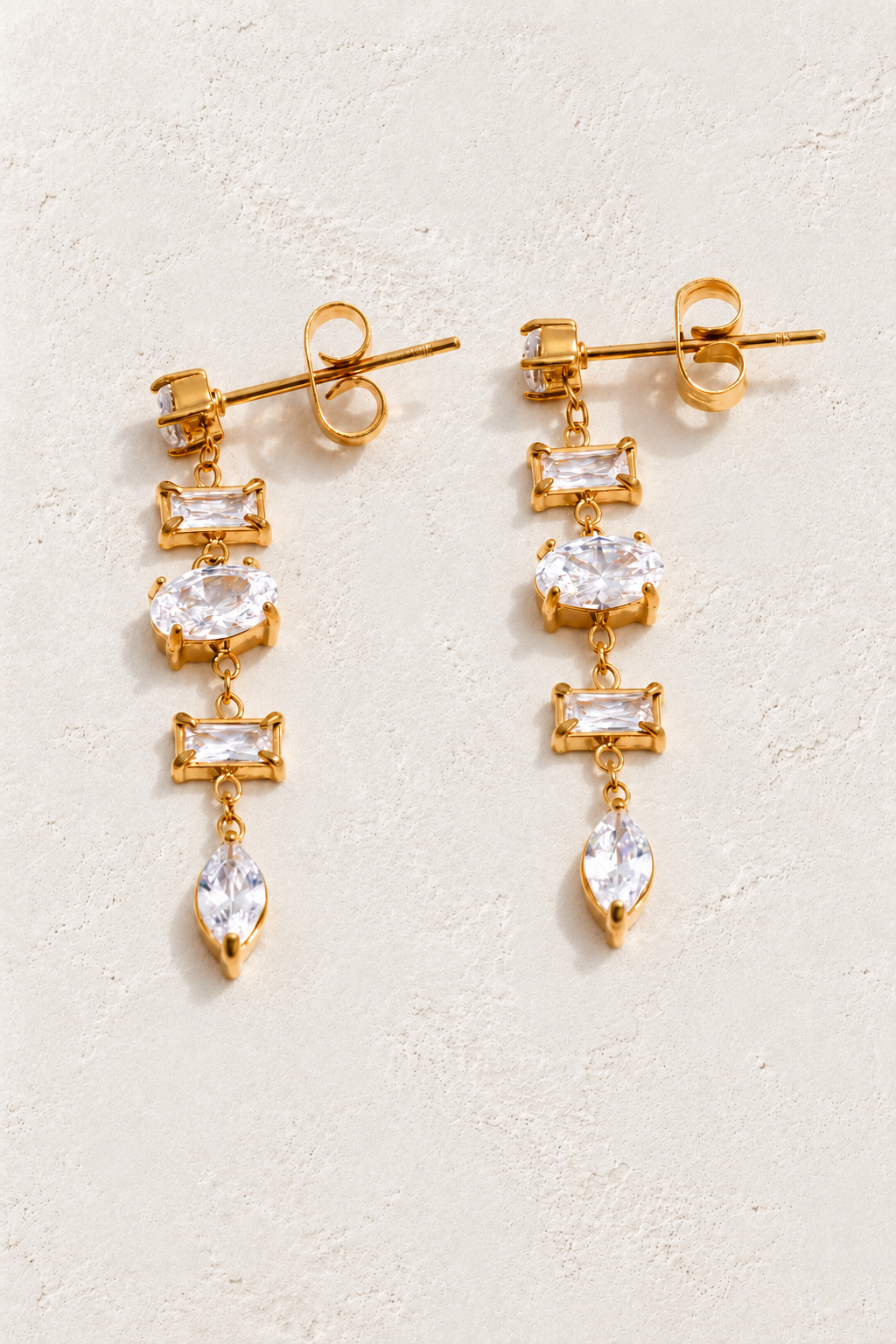
                  
                    Gold & Clear crystal cascade earrings on approved cream hero background
                  
                