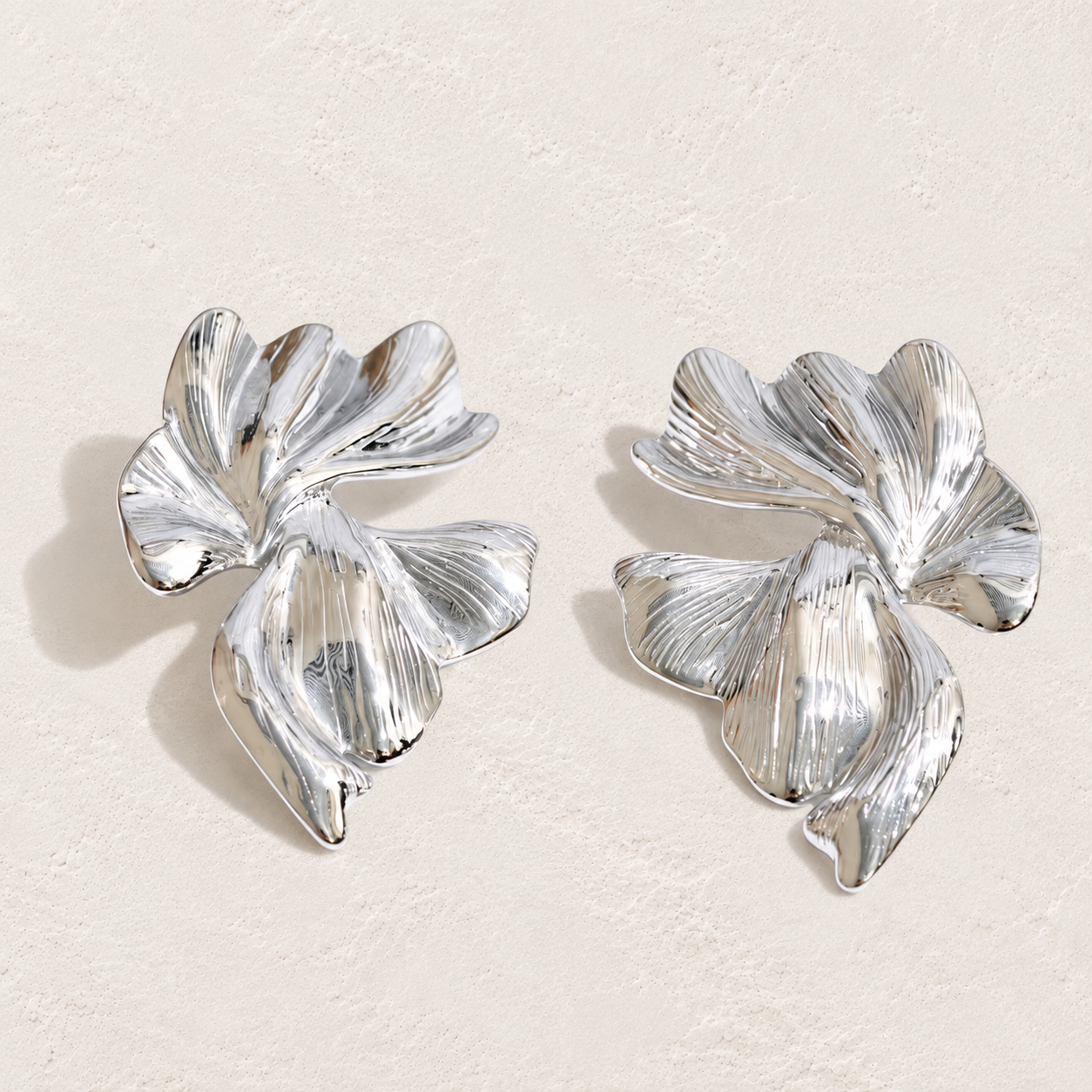 
                  
                    Sculpted Petal Statement Earrings on approved cream hero background
                  
                