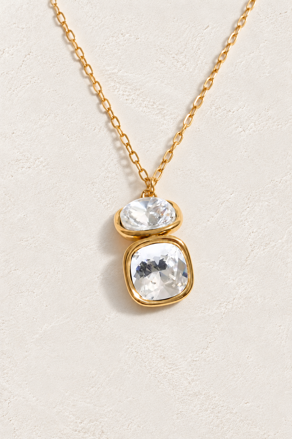 
                  
                    Double clear crystal gold necklace on approved cream hero background
                  
                