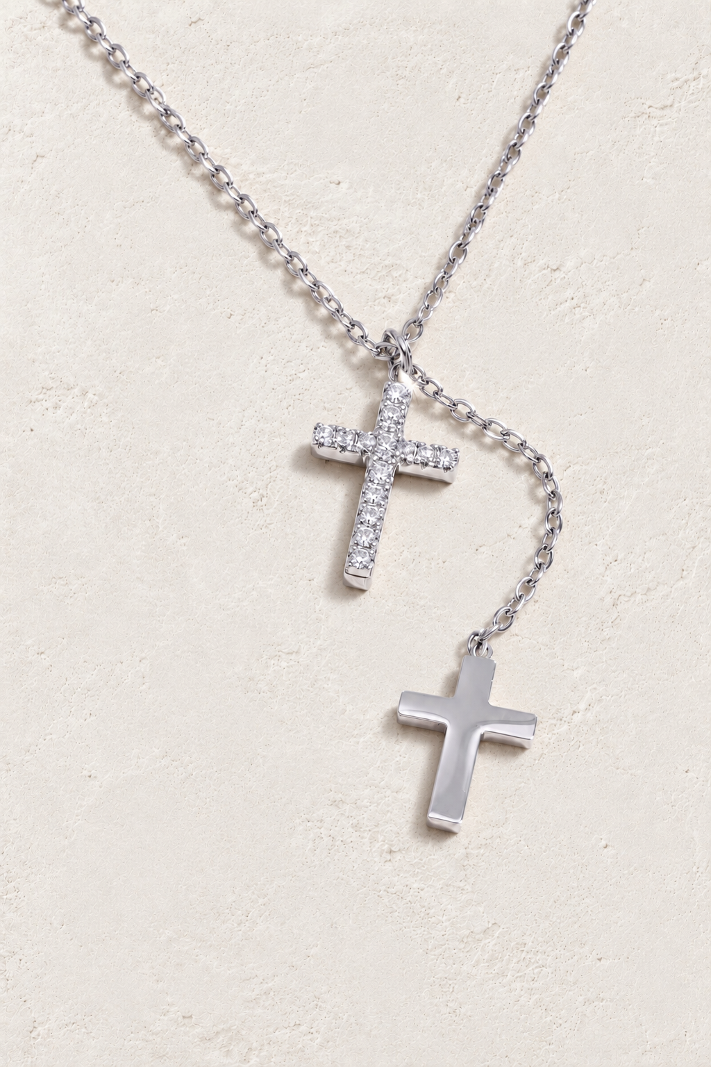 
                  
                    Silver double cross necklace on approved cream hero background
                  
                