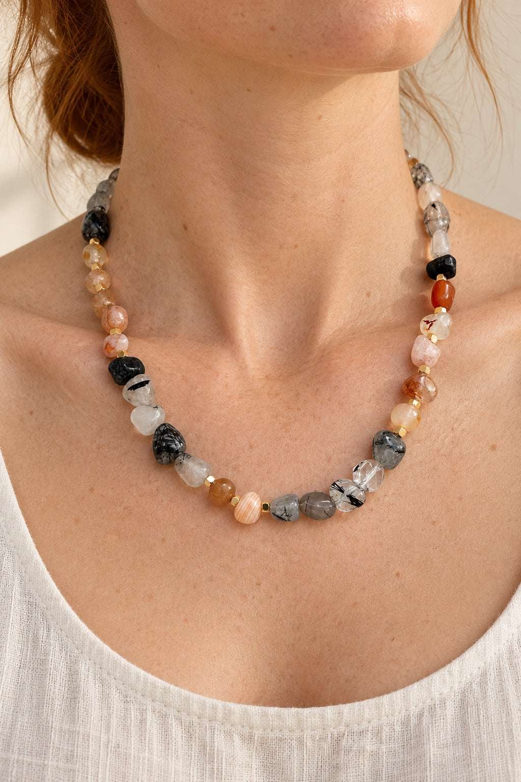 
                  
                    Model wearing the Arvela mixed gemstone gold-plated necklace
                  
                