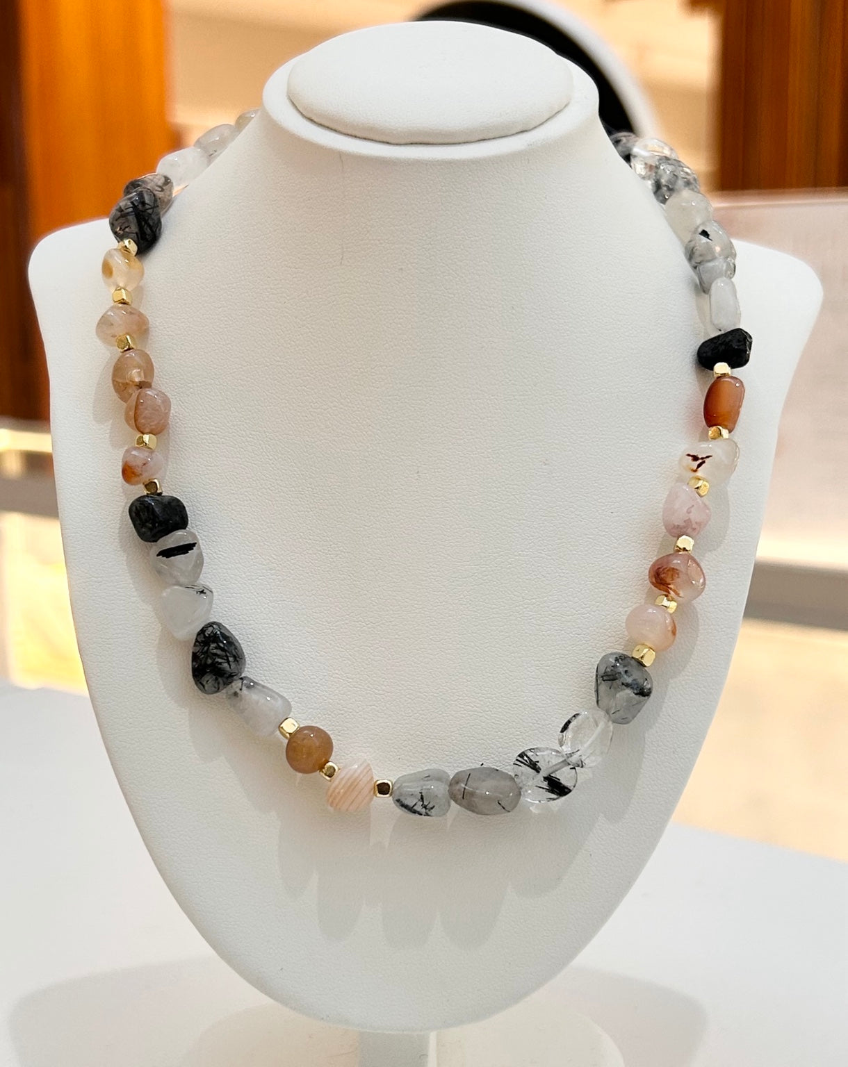 
                  
                    Arvela mixed stone necklace displayed on a white jewellery bust
                  
                