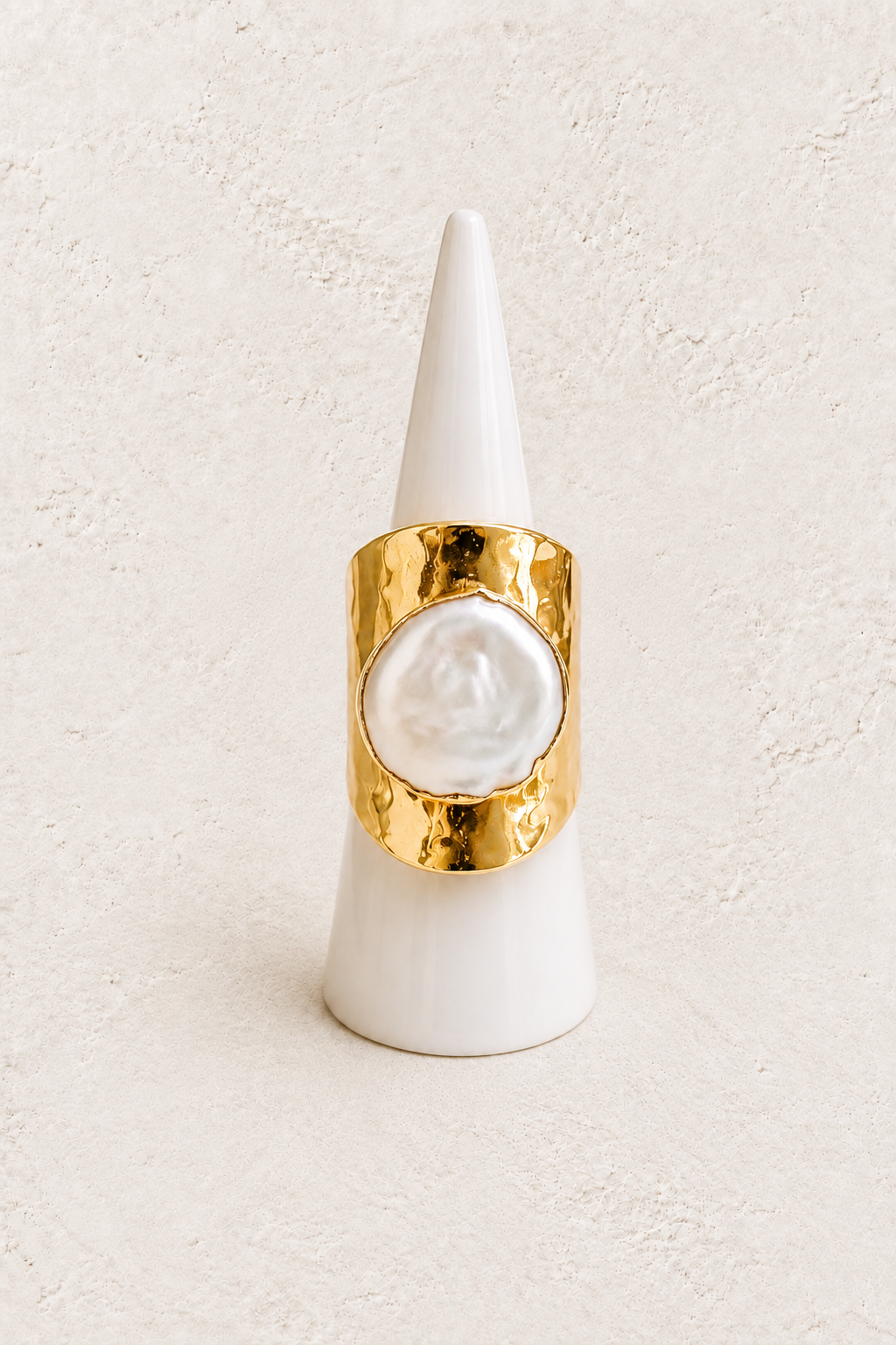 Aureline Freshwater Pearl Ring on white cone against warm textured background