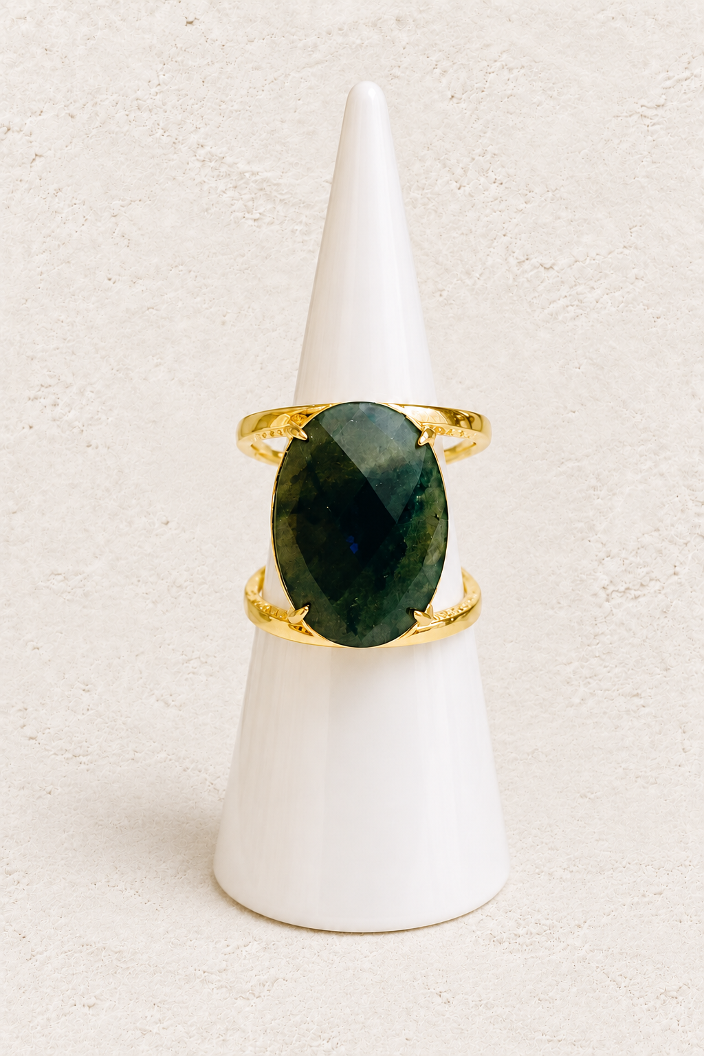 Aurevia Labradorite Statement Ring on white cone against warm textured background