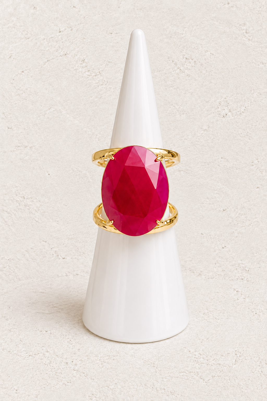 Aurevia Red Jade Statement Ring on white cone against warm textured background